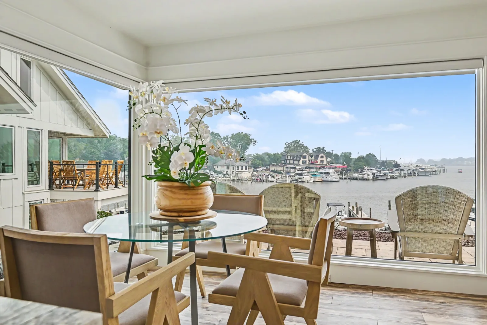 3 Bedroom Lake View — dining nook with orchid centerpiece and marina view