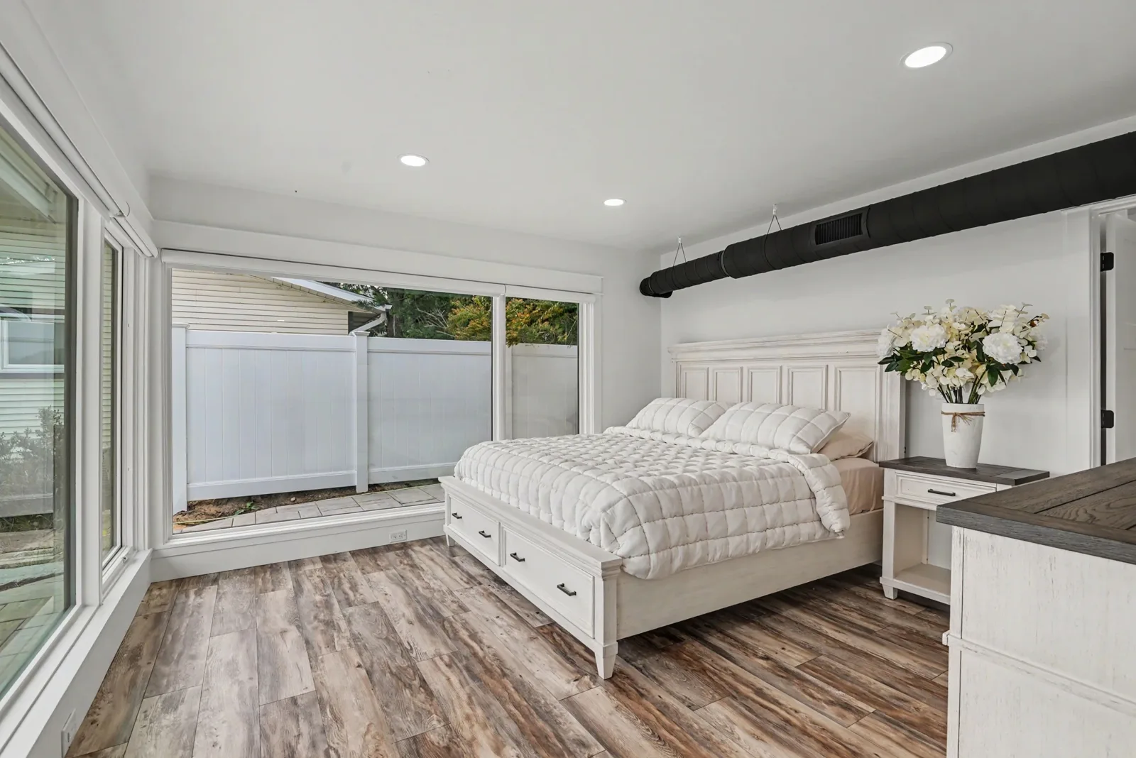 3 Bedroom Lake View — primary bedroom with king bed and waterfront windows
